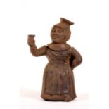 A Victorian cast iron match striker or vesta goto bed in the form of a woman holding a glass of gin.