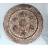 A 19th century Indian repousse copper tray with roundels depicting various deities within a