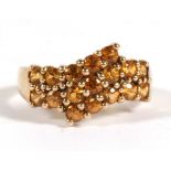 A 9ct gold dress ring set with seventeen yellow stones, approx UK size 'N'.