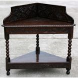 A Victorian carved oak corner table on bobbin turned supports, 100cms (39.5ins) wide.