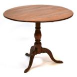 A 19th century tilt-top table on turned column and tripod base, 85cms (33.5ins) diameter.