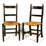 A pair of carved oak side chairs with rush seats, on turned front supports (2).