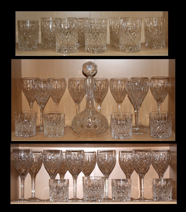 A large quantity of cut glass to include wine glasses, whiskey tumblers and a decanter.