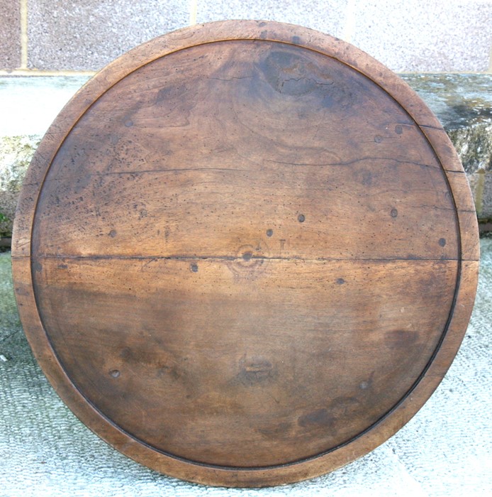 A large French walnut turned disc, possibly part of cheese press, 87cms (34.25ins) wide.