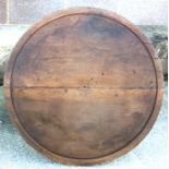 A large French walnut turned disc, possibly part of cheese press, 87cms (34.25ins) wide.