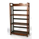 A stained pine four-tier open bookcase, 59cms (23ins) wide.