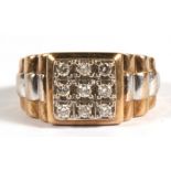 A gent's 9ct gold ring set with nine diamonds, approx UK size 'T'.