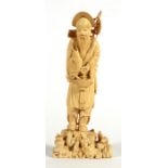 A late 19th century Japanese Meiji period carved ivory figure depicting a fisherman and his catch,
