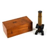 An early 20th century boxed field microscope.