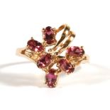A 10ct gold dress ring set with six pink stones, approx UK size 'S'.