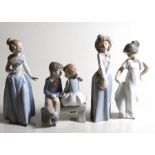 A group of Nao porcelain figurines, the largest 25cms (9.75ins) high.