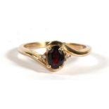 A 9ct gold garnet & diamond ring, approx UK size 'R'.