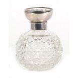 A silver topped cut glass scent bottle, Birmingham 1916, 9cms (3.5ins) high.