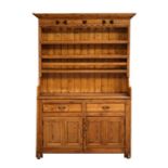 A stripped pine dresser with two frieze drawers above cupboards, 135cms (53ins) wide.