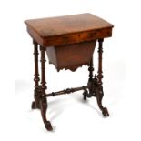 A Victorian figured walnut sewing table on turned supports, the interior refitted, 54cms (21.