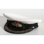 A Royal Navy Commodores cap with bullion wire oak leaves to visor, by Gieves of London.
