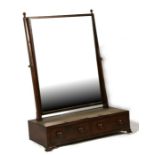 A Victorian mahogany toilet mirror with two short drawers, on bracket feet, 55cms (21.5ins) wide.