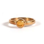 A 9ct gold dress ring set with an amber coloured cabochon, approx UK size 'K'.