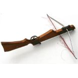 A modern crossbow with walnut stock, 92cms (36.25ins) long.