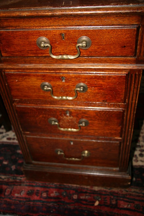 An early 20th century oak twin pedestal partner's desk, the top with green inset leather top, - Image 8 of 11