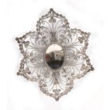 An Arabic flower shaped white metal coin dish, 16cms (6.25ins) diameter.
