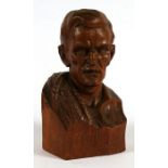 An early 20th century wooden carving in the form of a gentleman's head with a rope coiled across his