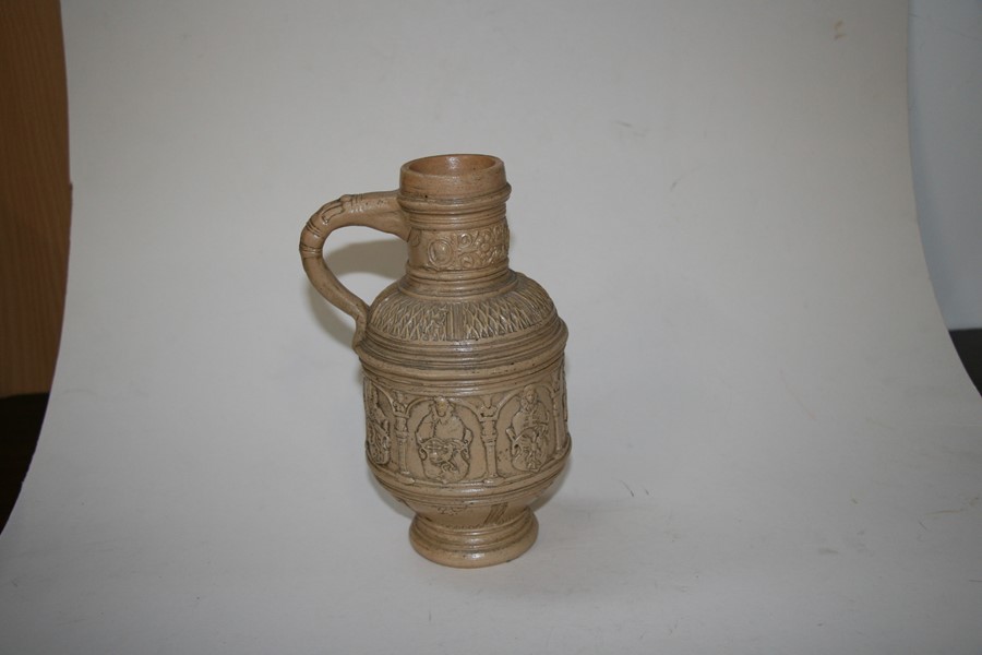 A German stoneware jug decorated with figures and heraldic crests, 22cms (8.5ins) high.Condition - Image 4 of 8