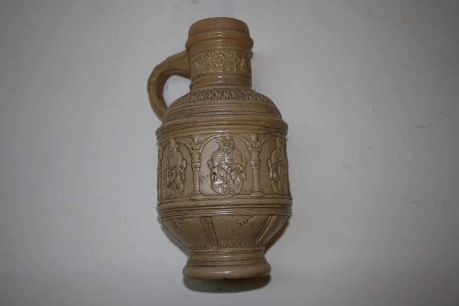 A German stoneware jug decorated with figures and heraldic crests, 22cms (8.5ins) high.Condition - Image 2 of 8
