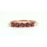 A 9ct gold dress ring set with five pink stones, approx UK size 'P'.