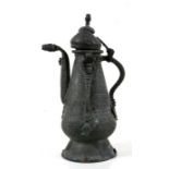 A Middle Eastern copper coffee pot with engraved decoration and Arabic calligraphy, 34cms (13.