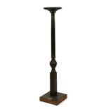 A mahogany torchere on a carved and reeded column.