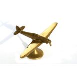 A large brass model of the WW2 Supermarine Spitfire with spinning propeller, mounted on a brass