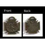 A WW1 French medal showing soldiers charging into battle on the front whilst on the reverse