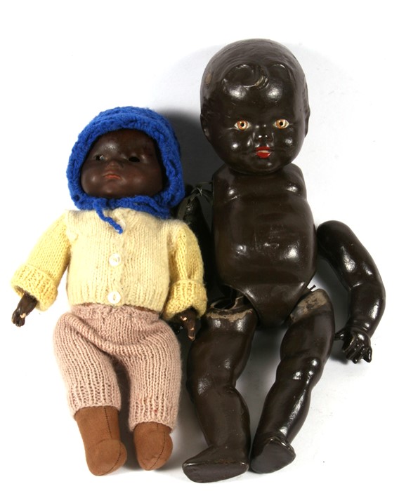 An Armand Marseilles black bisque headed doll, 32cms (11.75ins) high; together with a black