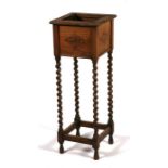 An early 20th century oak plant stand, on barley twist supports, 32cms (12.5ins) wide.Condition