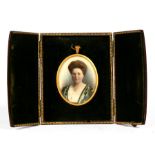 An Edwardian oval portrait miniature, 5.5 by 7cms (2.2 by 2.75ins) in a leather strut display case.