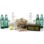 A stoneware cheese preserver; together with two cut glass decanters; four glass lemonade bottles;