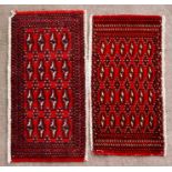 A pair of Persian Baluch woollen handmade rugs with geometric design on a red ground, each 105 by