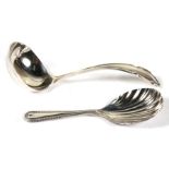 A silver caddy spoon with shell shaped bowl; together with a silver sauce ladle (2).