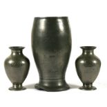 A German pewter vase with inscription and dated 1945 (date has been defaced), 18cms (7ins) high;