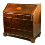 A 19th century mahogany bureau, the inlaid fall flap enclosing a fitted interior above two short and