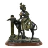 A 20th century bronze group depicting a girl riding a donkey, signed 'Ernest Wante' with foundry