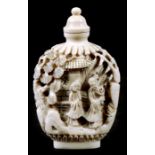 A Chinese deeply carved ivory snuff bottle decorated with figures in a landscape, 7.5cms (3.5ins)