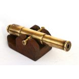A brass barrelled signal cannon sitting on a wooden carriage. Barrel length 15.5cms (6ins) with an