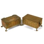 A pair of Dutch style brass table top cigarette boxes decorated with figures and birds, one named to