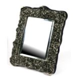 A Victorian style white metal (untested) strut mirror decorated in relief with cherubs, 29cms (11.