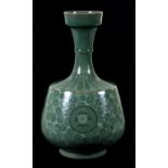 A Korean green glazed vase decorated with foliate scrolls, 26cms (10.25ins) high.