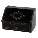 A 19th century French ebonised stationary box with sectioned interior, 21cms (8.25ins) wide.