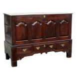 An 18th century Welsh oak dowry chest, the panelled front above three drawers, 142cms (56ins) wide.