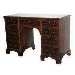 A Victorian mahogany kneehole desk with an arrangement of nine drawers, on bracket feet, 120cms (